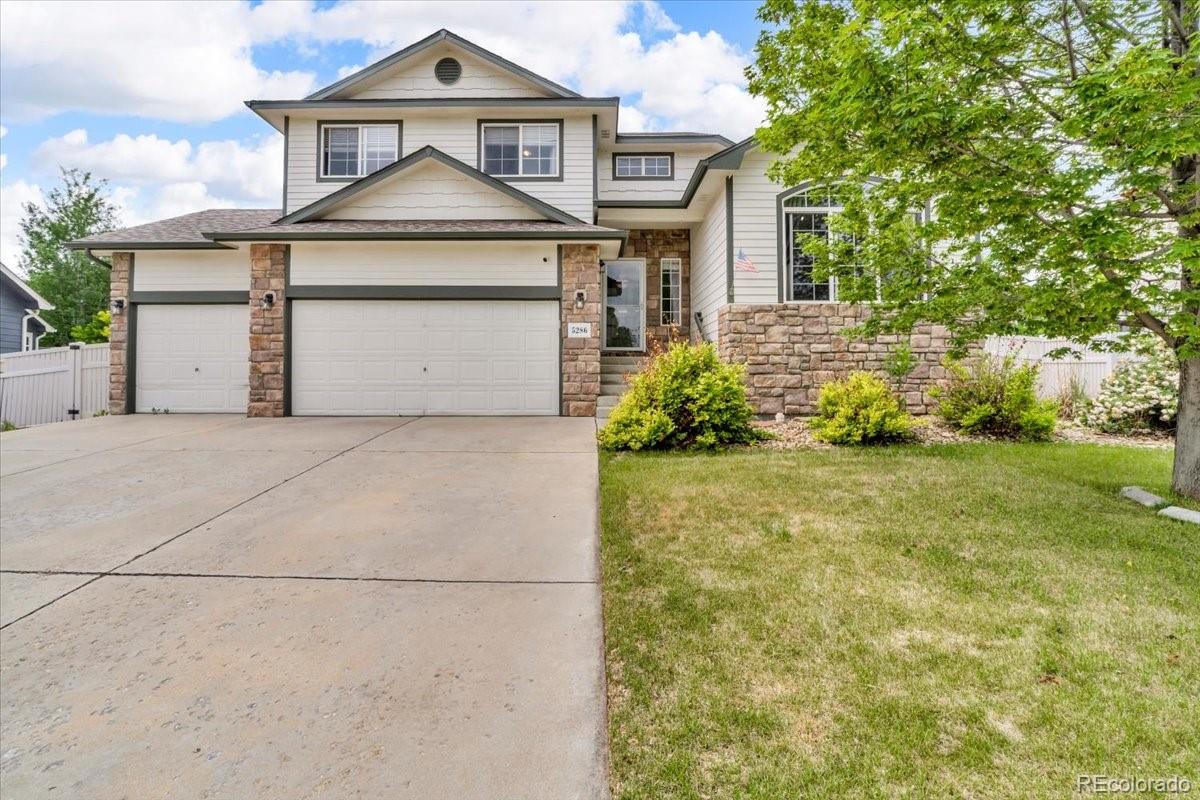 a front view of a house with a yard and garage
