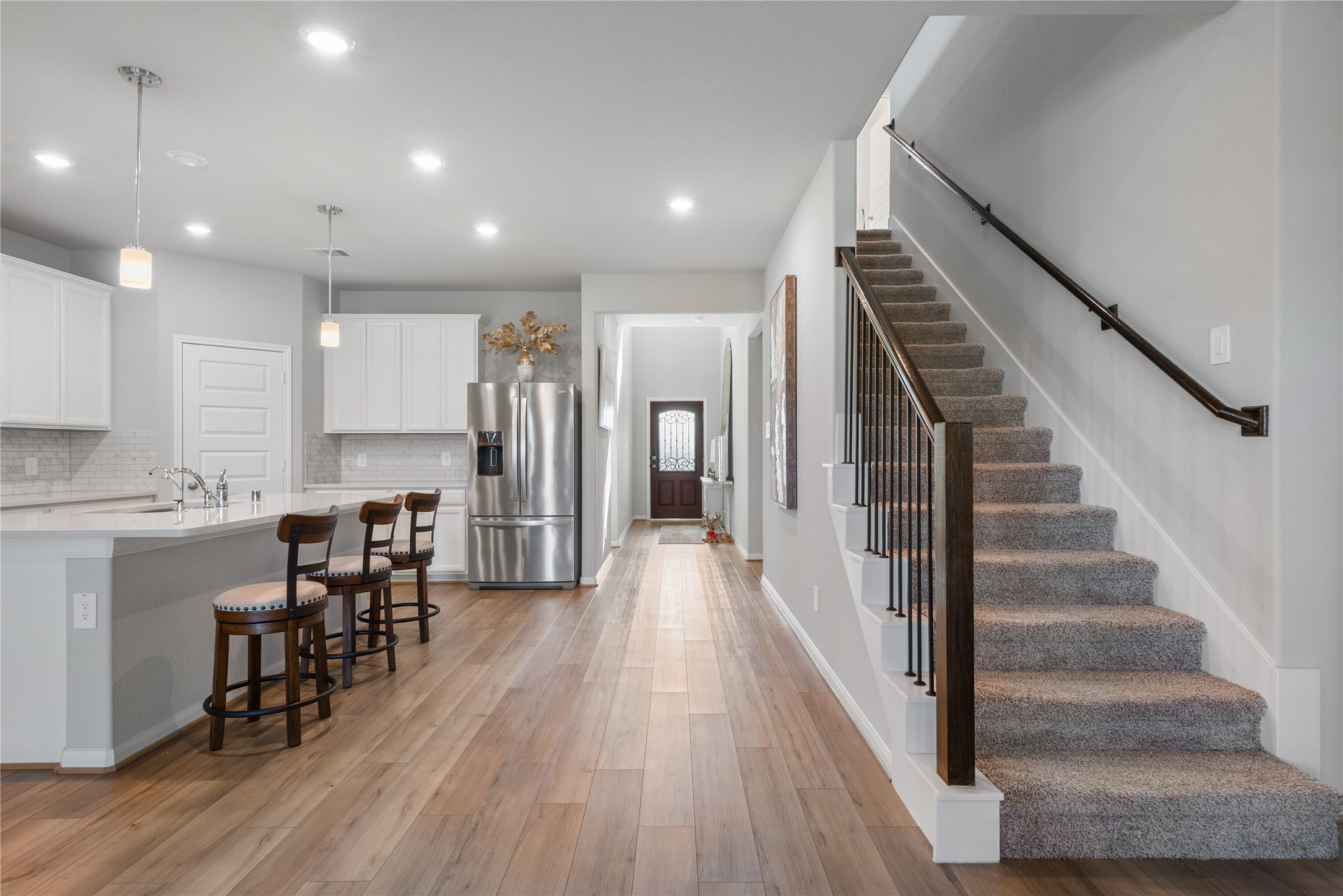 1203 Cascade Hls Drive Rosharon, TX 77583 - Photo 2 of 25 a view of a dining area with wooden floor and chairs