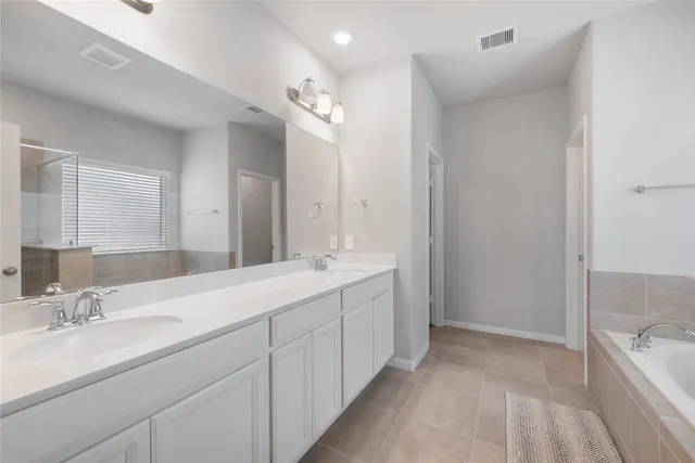 a bathroom with a double vanity sink mirror and