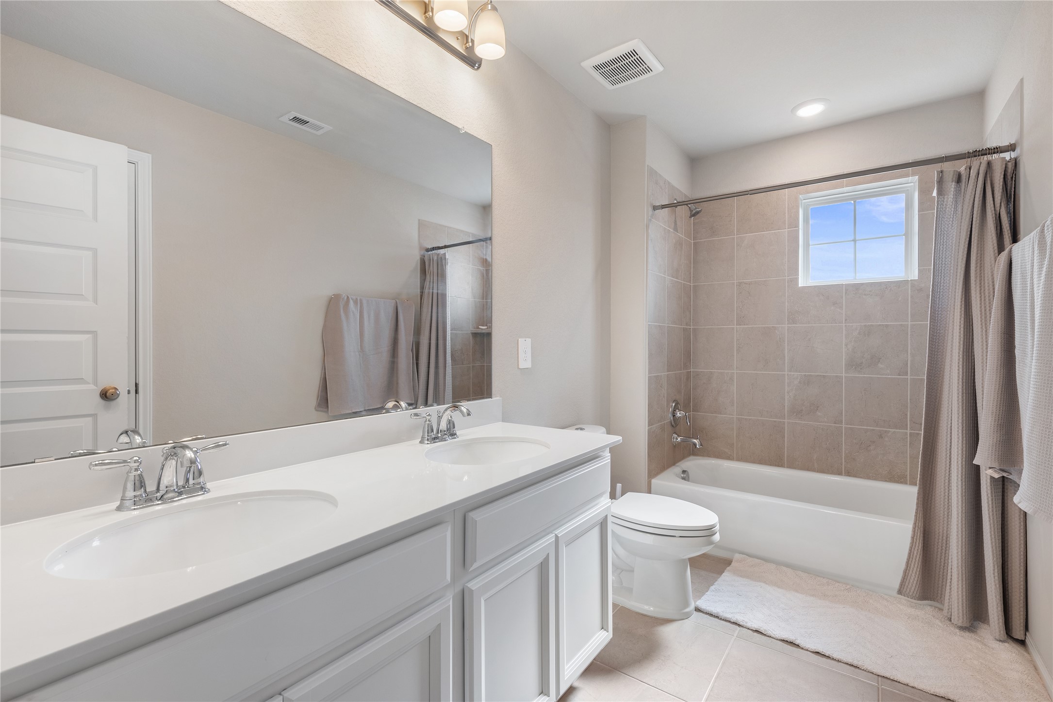 1203 Cascade Hls Drive Rosharon, TX 77583 - Photo 23 of 25 a bathroom with a double vanity sink toilet mirror and shower