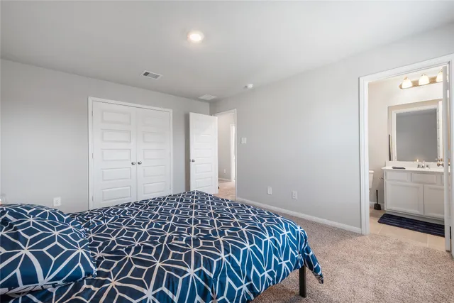 a bedroom with a bed and a view of bathroom