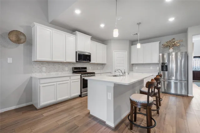 a kitchen with a sink stainless steel appliances and cabinets