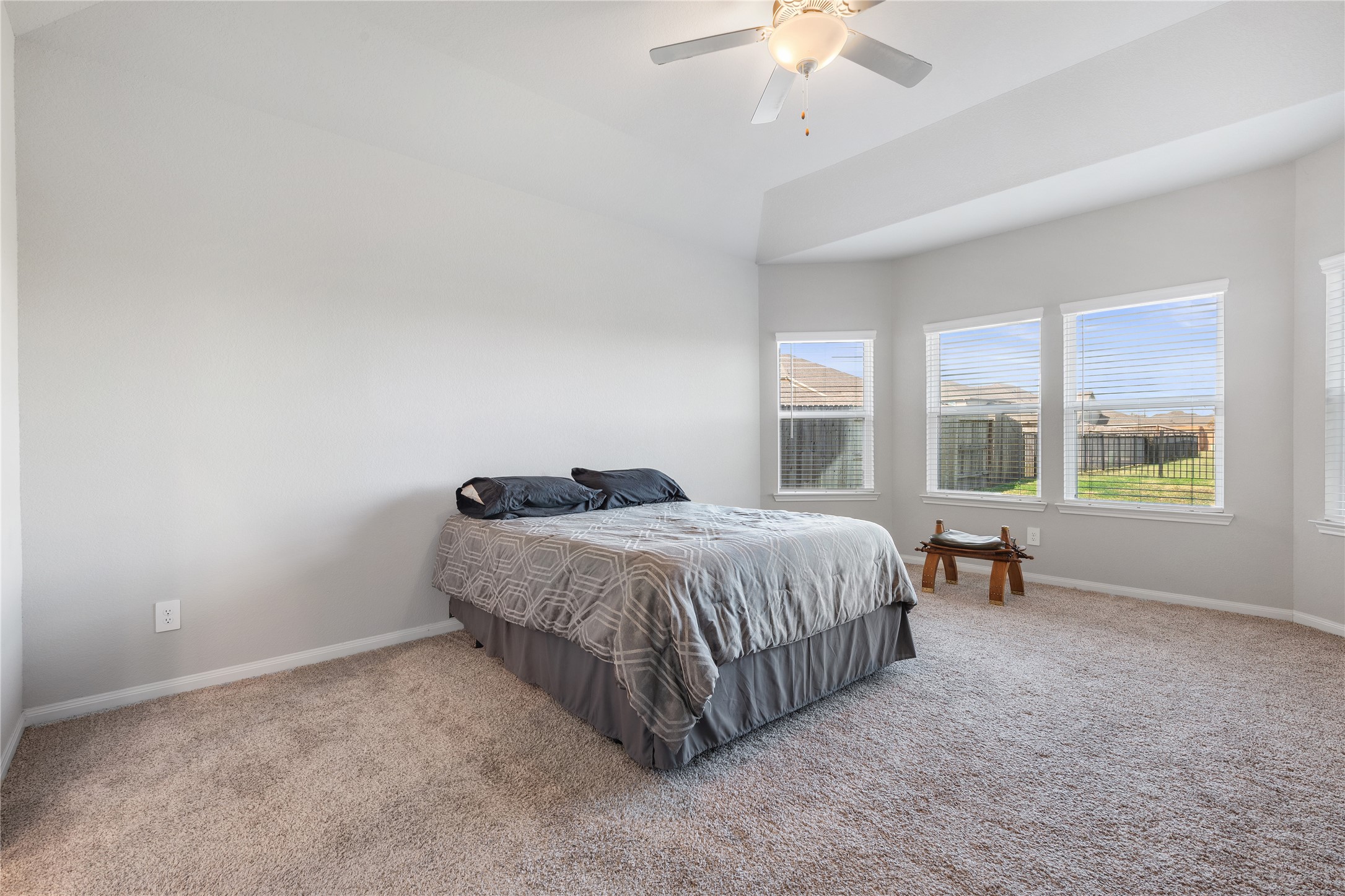 1203 Cascade Hls Drive Rosharon, TX 77583 - Photo 7 of 25 a spacious bedroom with a bed and a chandelier