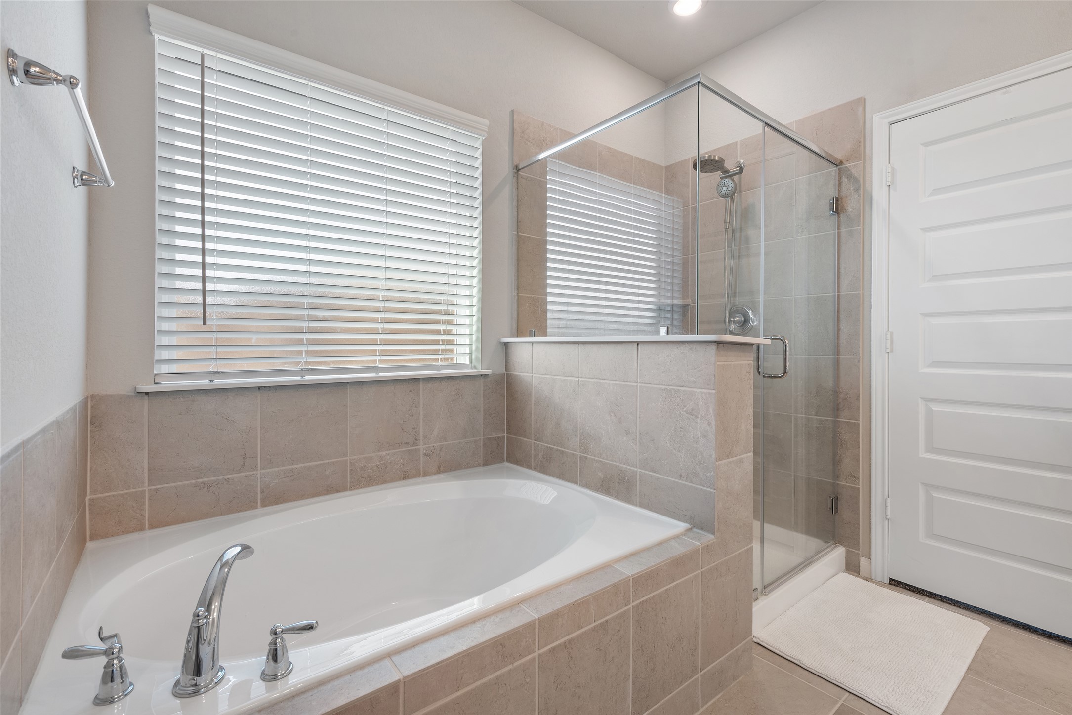 1203 Cascade Hls Drive Rosharon, TX 77583 - Photo 9 of 25 a white bath tub sitting in a bathroom next to a window