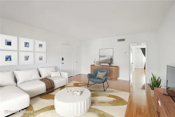a living room with furniture and wooden floor