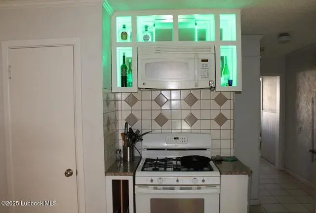 a stove top oven sitting inside of a kitchen