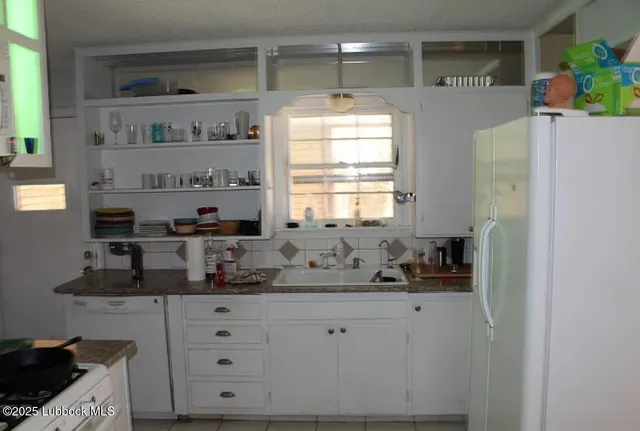 a kitchen with stainless steel appliances a sink and a refrigerator