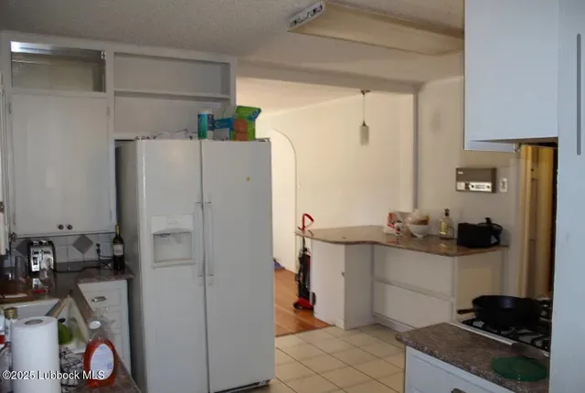 a kitchen with a refrigerator and a stove top oven