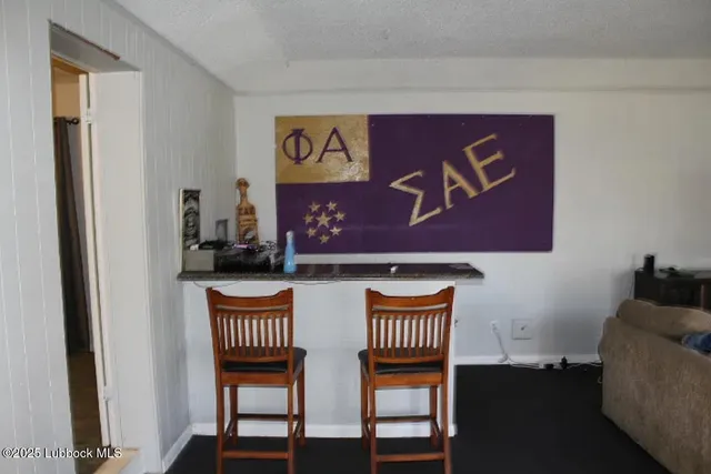 a view of a room with furniture and wooden floor