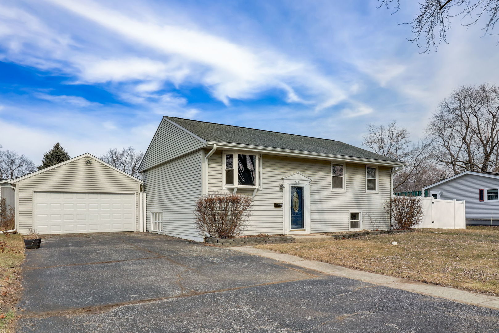 560 Willow Road Wauconda, IL 60084 - Photo 1 of 24 a view of a white house with a yard and garage