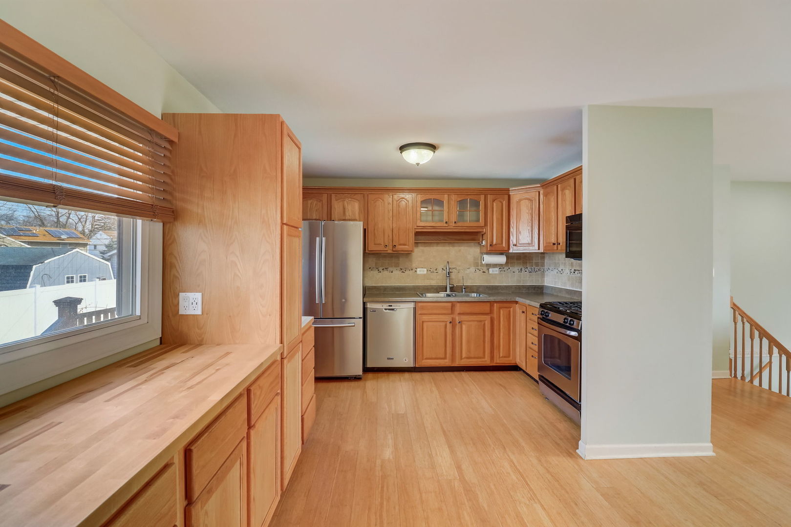 560 Willow Road Wauconda, IL 60084 - Photo 6 of 24 a kitchen with a refrigerator sink and cabinets