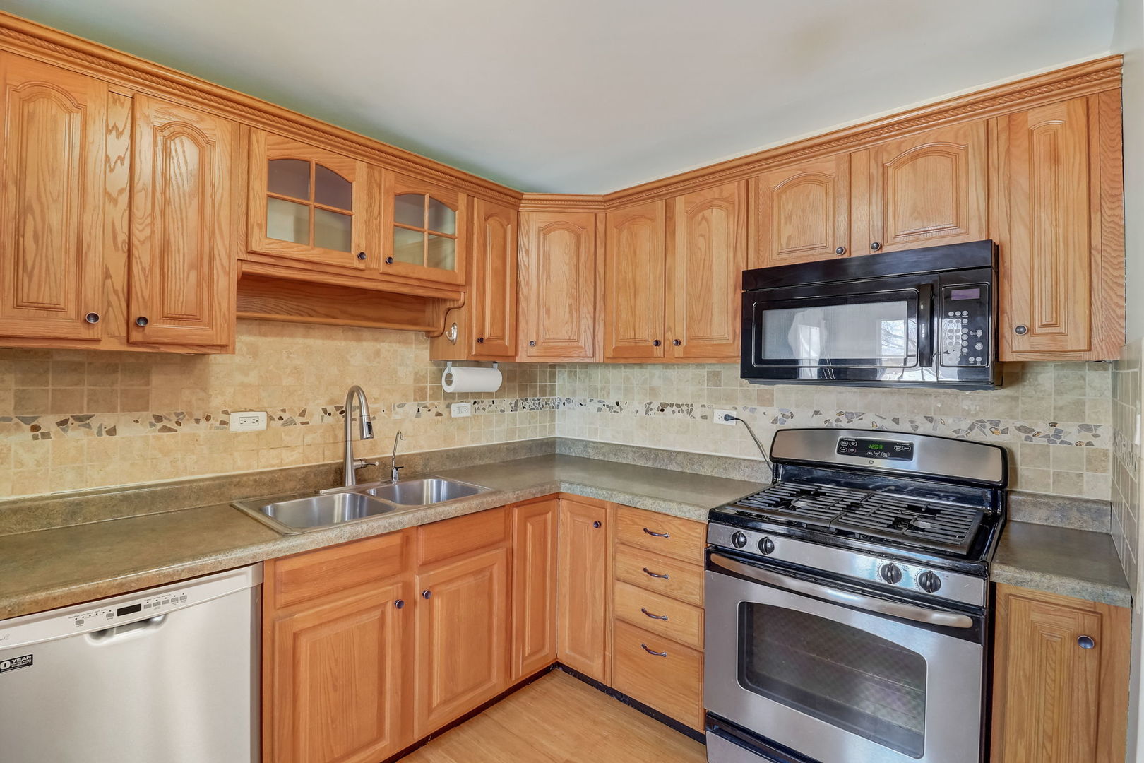 560 Willow Road Wauconda, IL 60084 - Photo 8 of 24 a kitchen with granite countertop a stove sink and cabinets