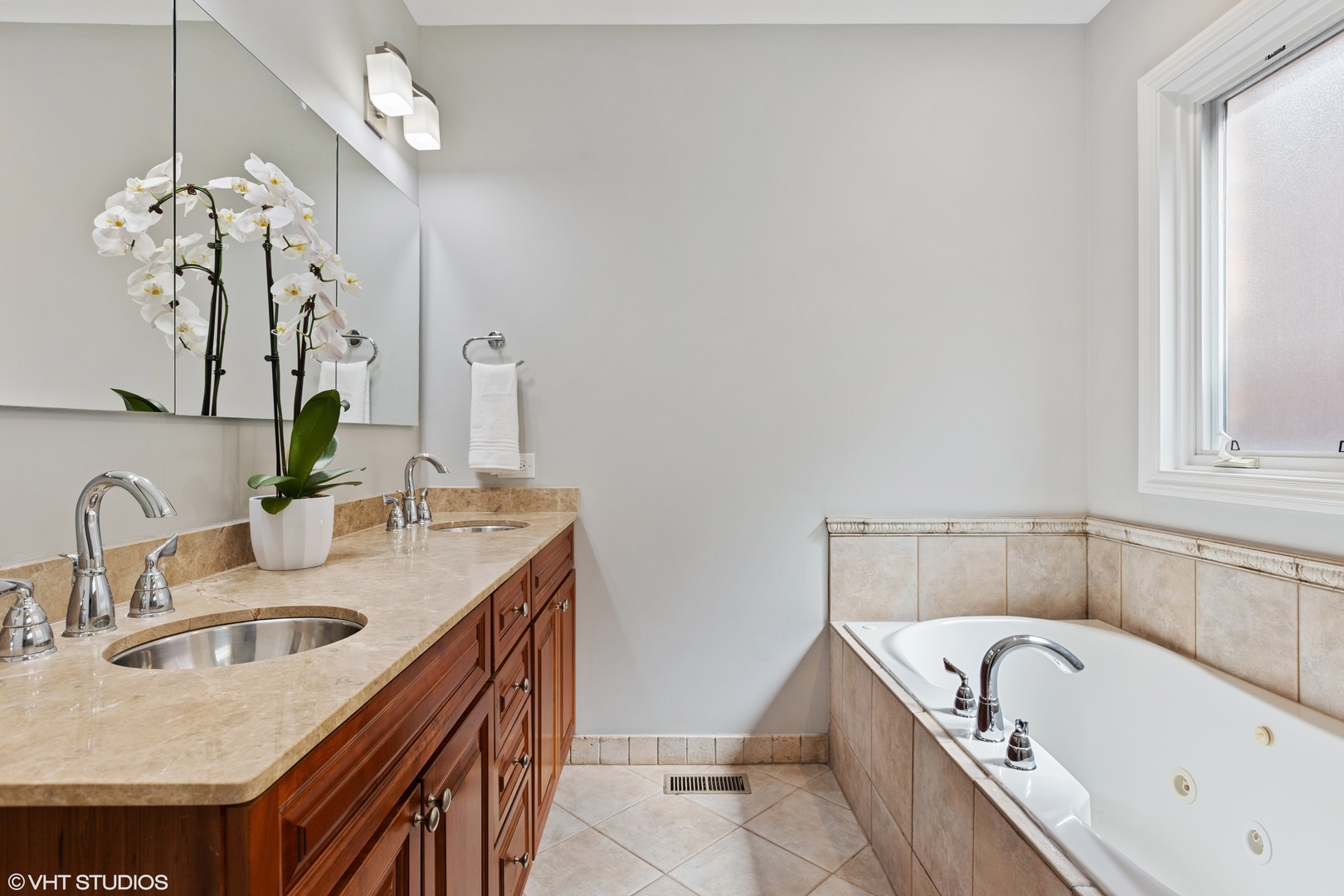 2038 West Race Avenue Chicago, IL 60612 - Photo 15 of 35 a bathroom with a granite countertop sink a bathtub and mirror