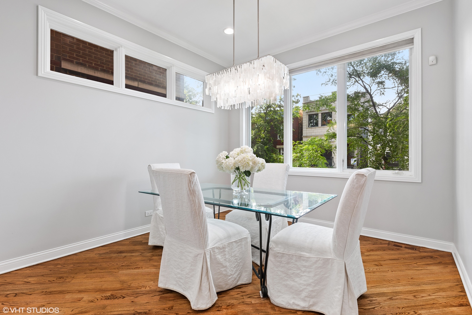 2038 West Race Avenue Chicago, IL 60612 - Photo 3 of 35 a view of a dining room with furniture a chandelier and wooden floor