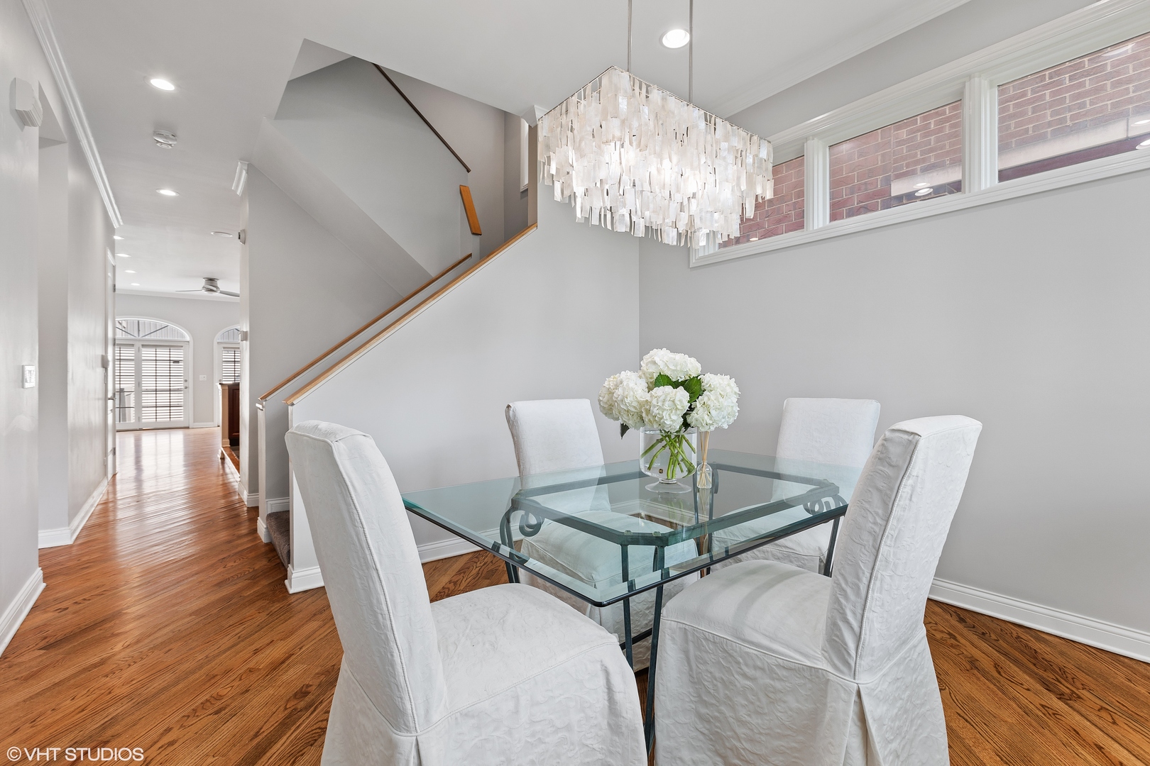 2038 West Race Avenue Chicago, IL 60612 - Photo 4 of 35 a view of a dining room with furniture a chandelier and wooden floor