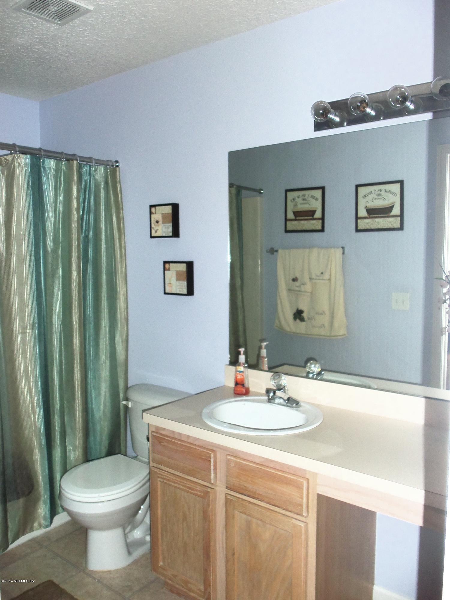 9732 Chirping Way Jacksonville, FL 32222 - Photo 13 of 27 a bathroom with a sink toilet and shower