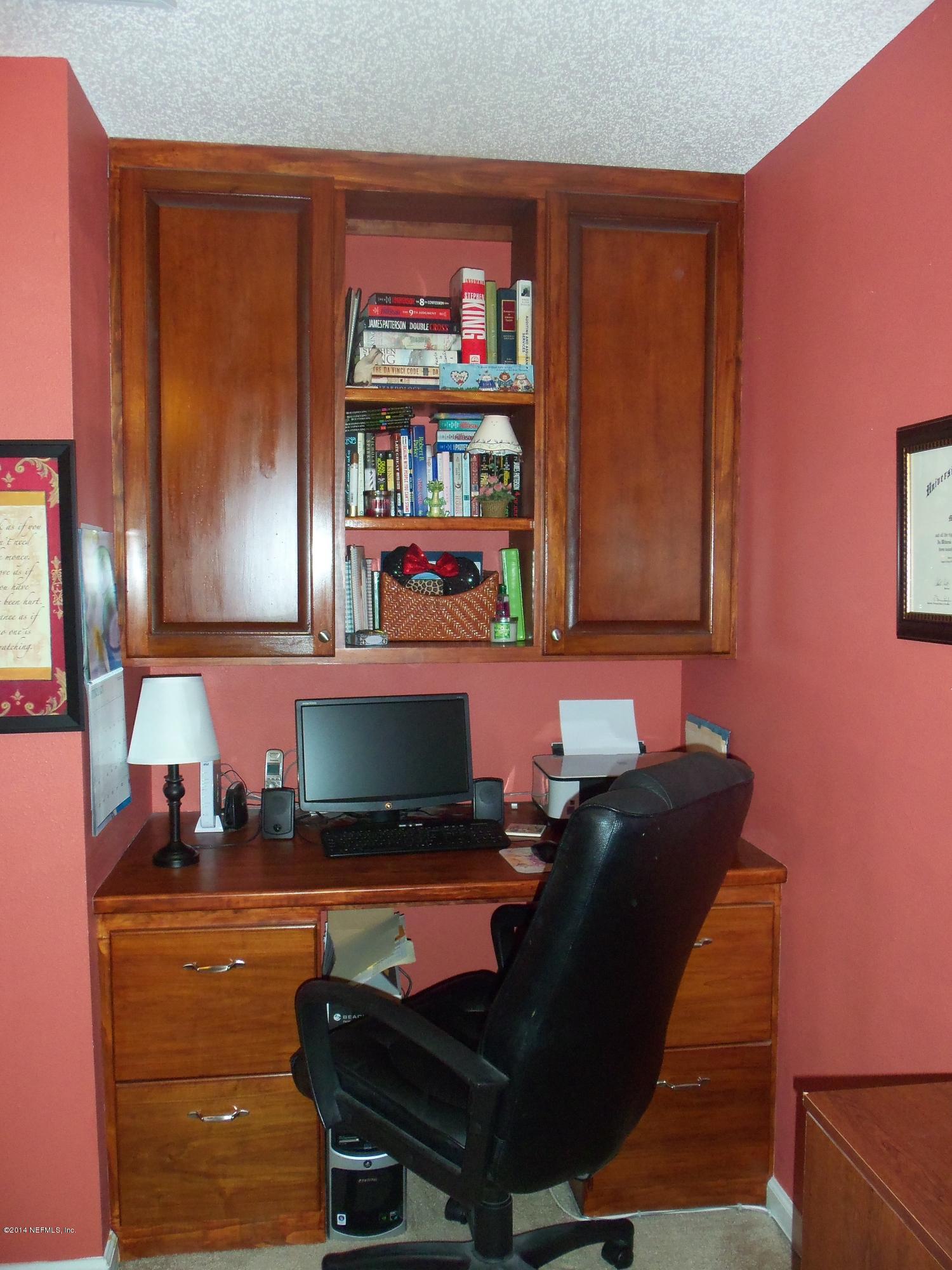 9732 Chirping Way Jacksonville, FL 32222 - Photo 17 of 27 a living room with furniture and a bookshelf