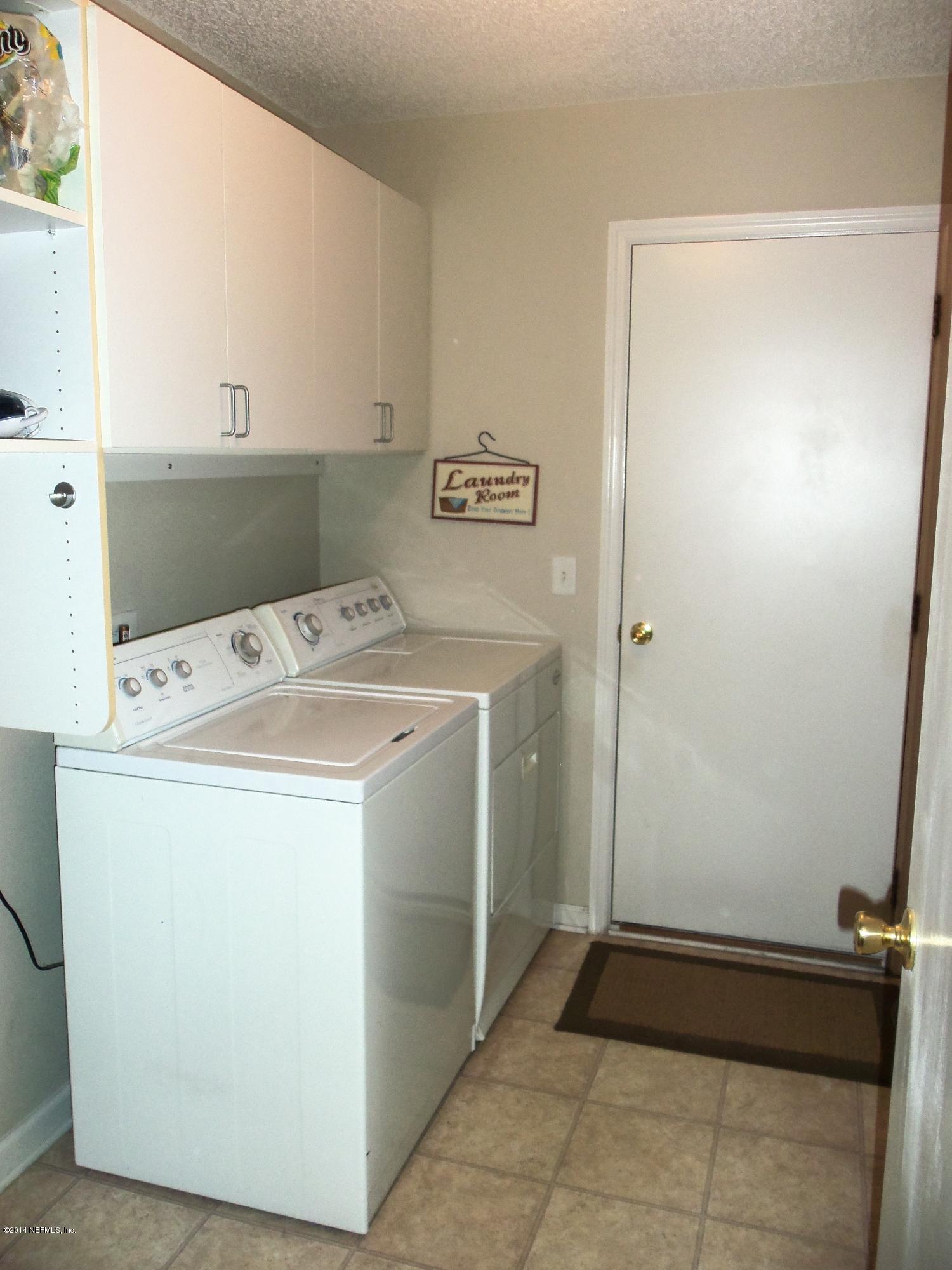 9732 Chirping Way Jacksonville, FL 32222 - Photo 18 of 27 a utility room with dryer and washer