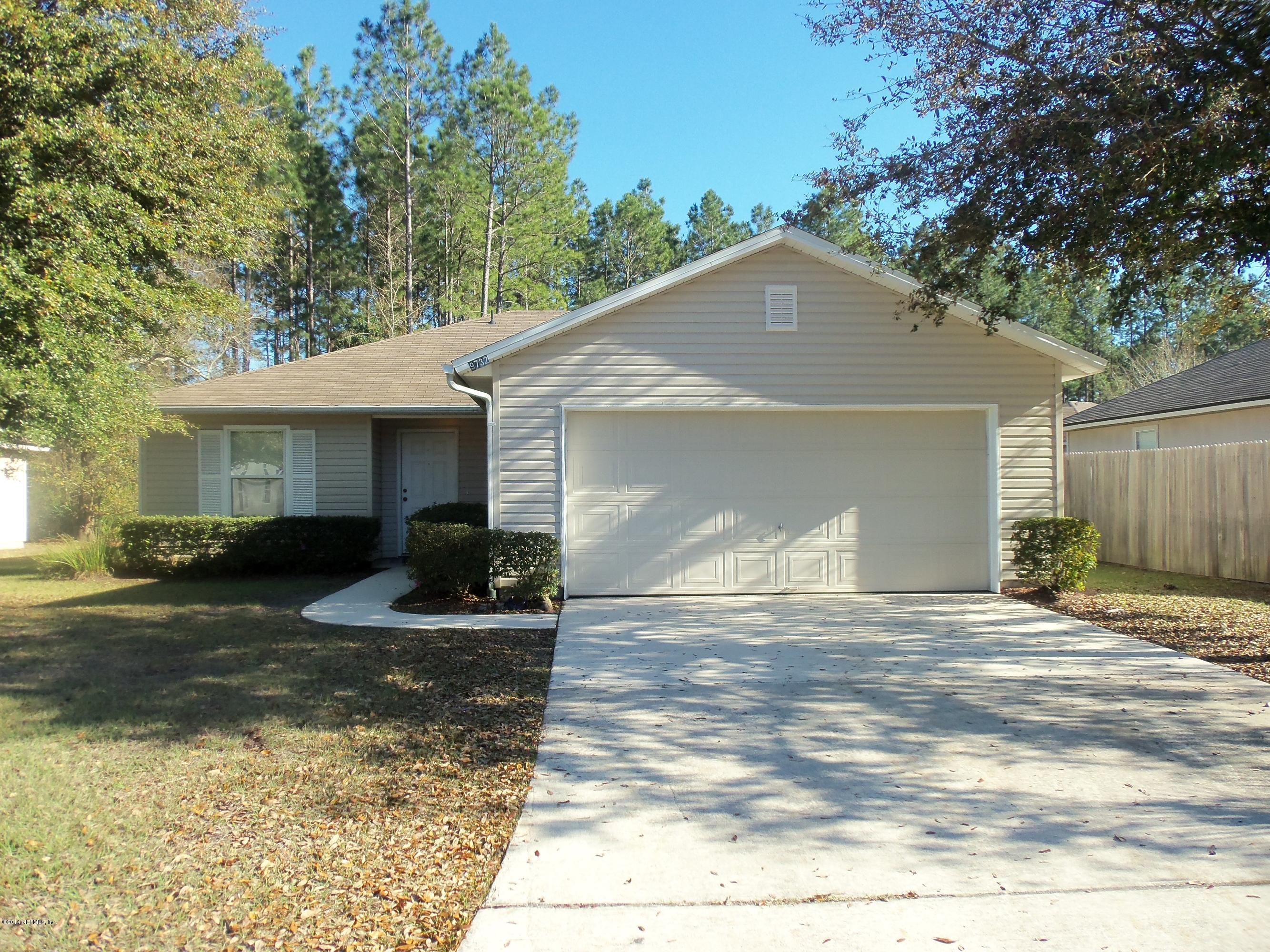 9732 Chirping Way Jacksonville, FL 32222 - Photo 2 of 27 a front view of a house with yard