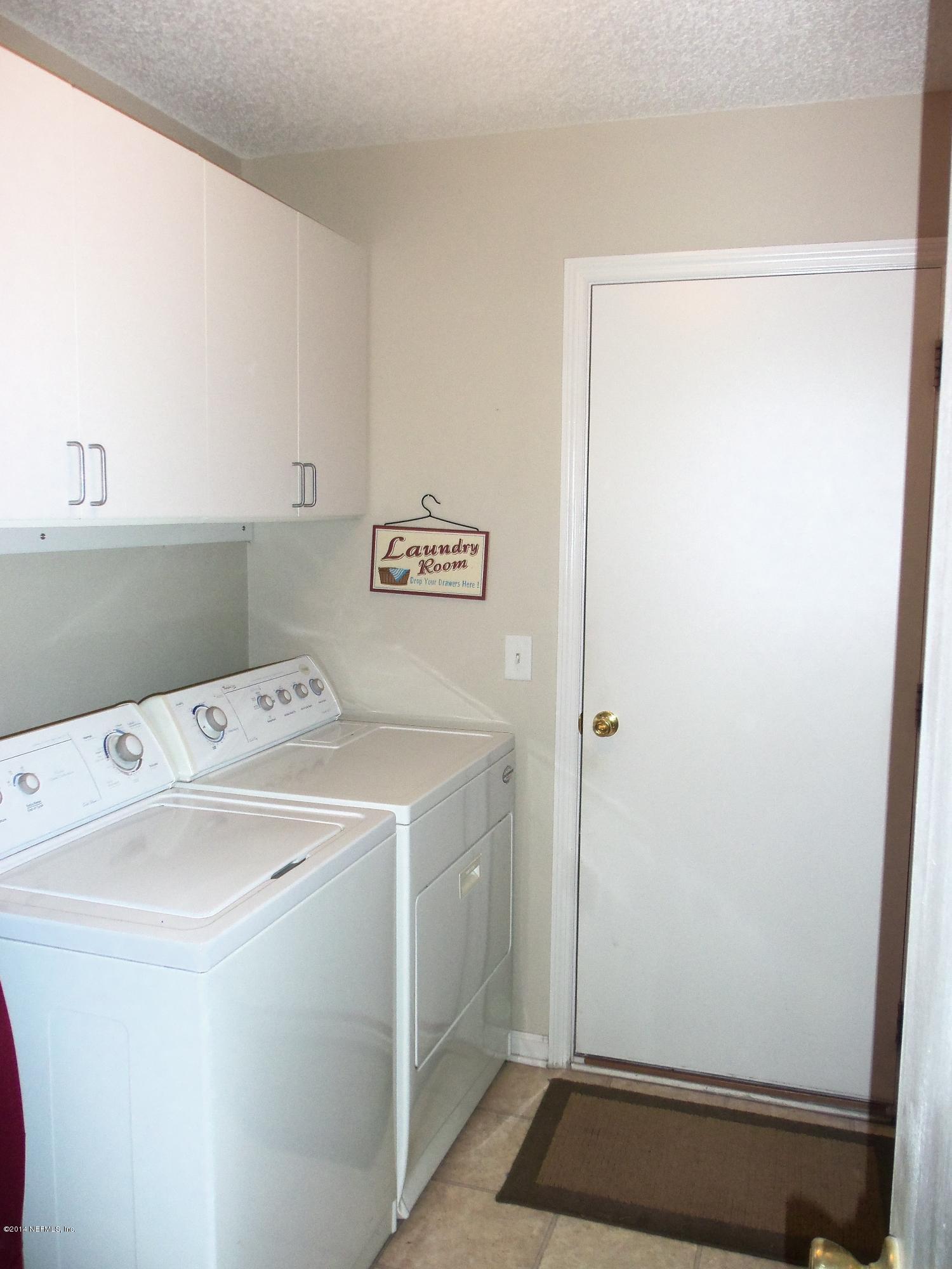 9732 Chirping Way Jacksonville, FL 32222 - Photo 21 of 27 a utility room with dryer and washer