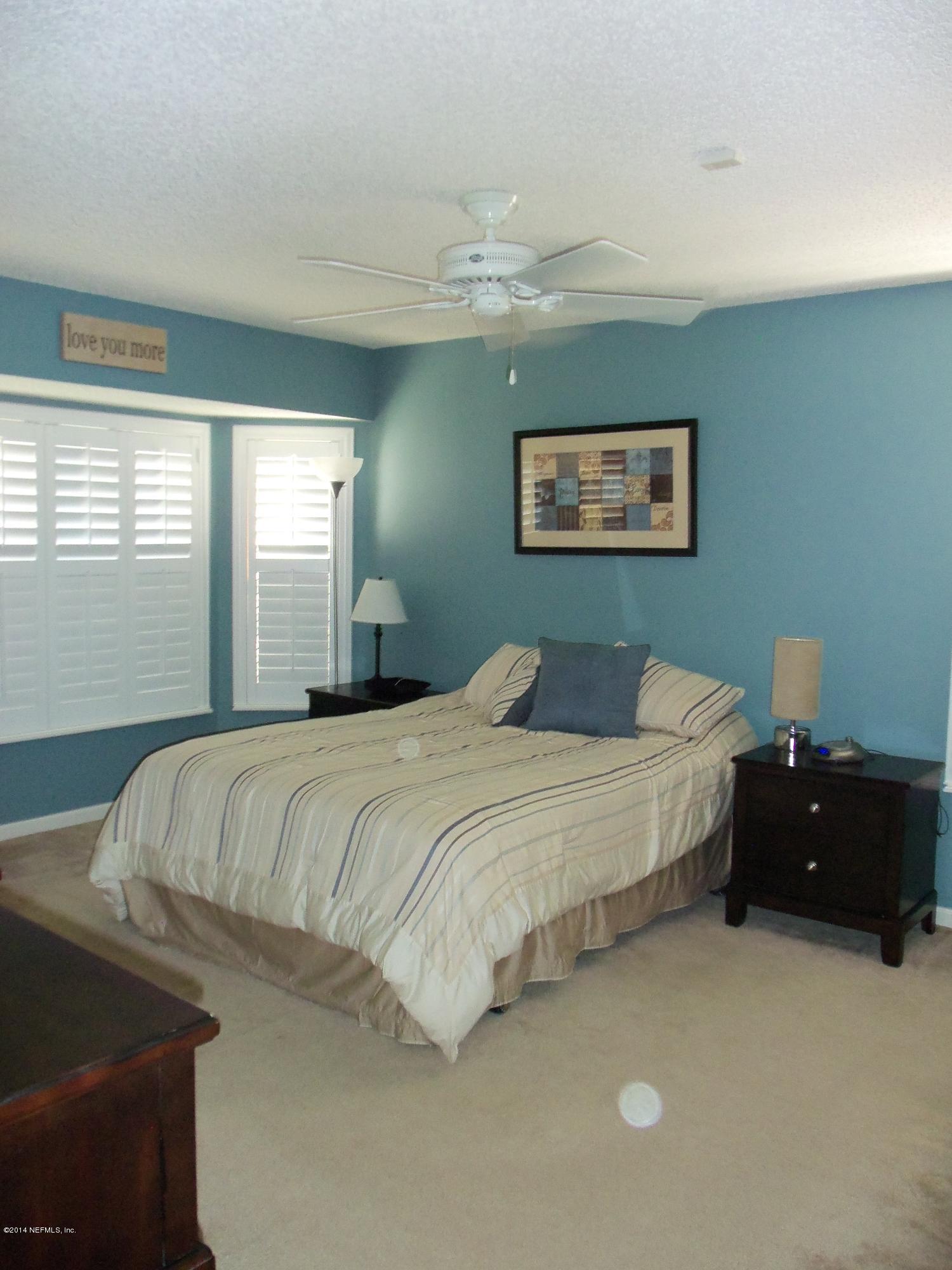 9732 Chirping Way Jacksonville, FL 32222 - Photo 23 of 27 a bedroom with a bed and a window