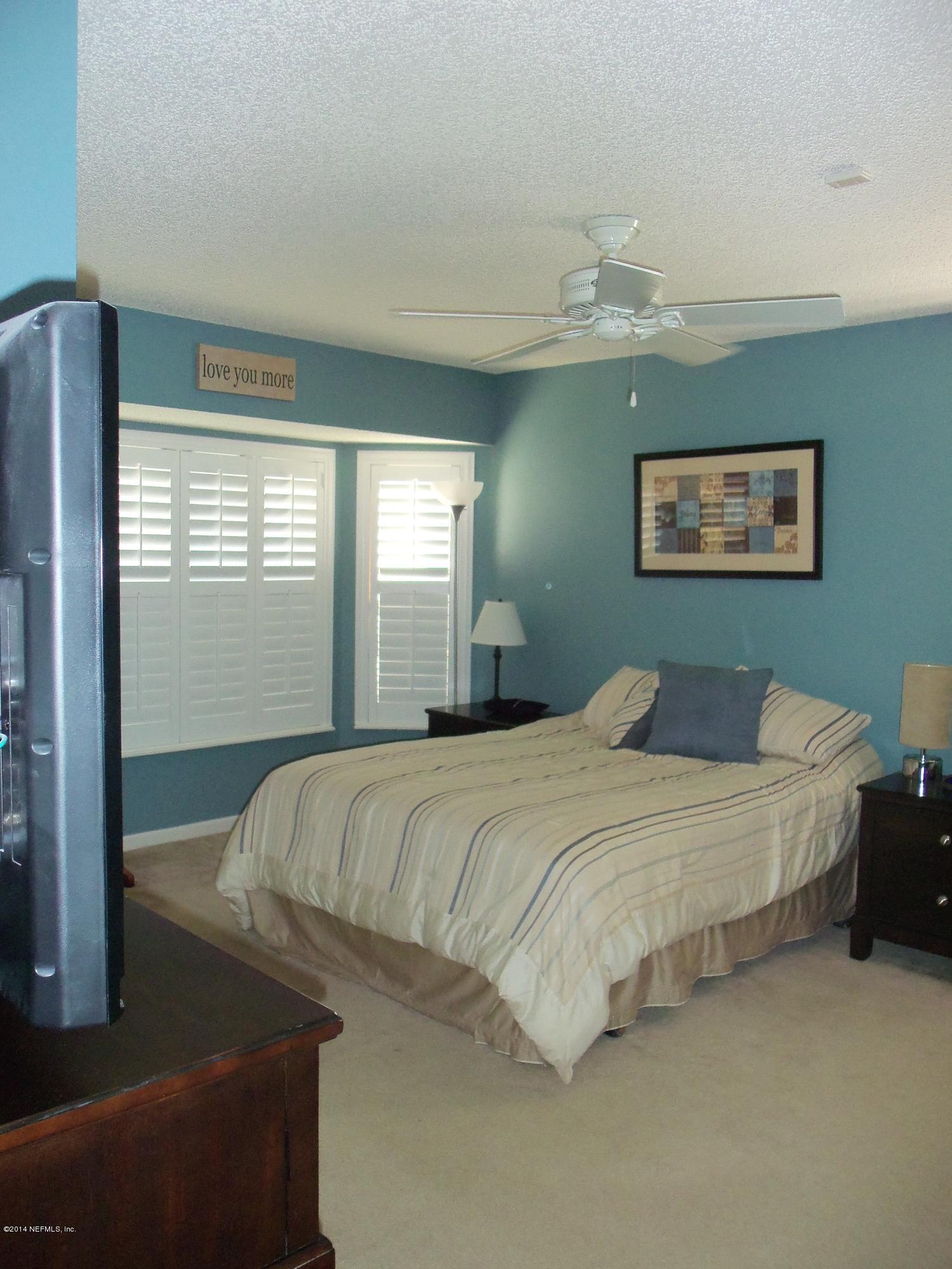 9732 Chirping Way Jacksonville, FL 32222 - Photo 24 of 27 a bedroom with bed and window