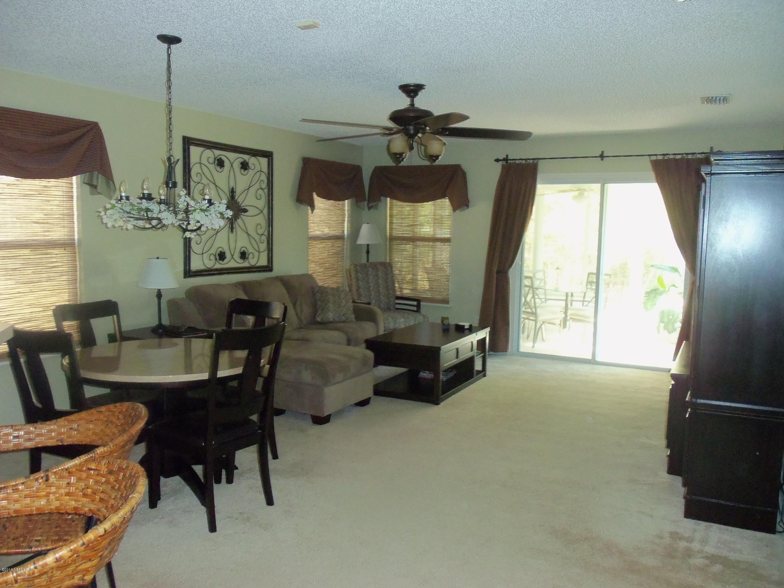 9732 Chirping Way Jacksonville, FL 32222 - Photo 6 of 27 a living room with furniture and a large window