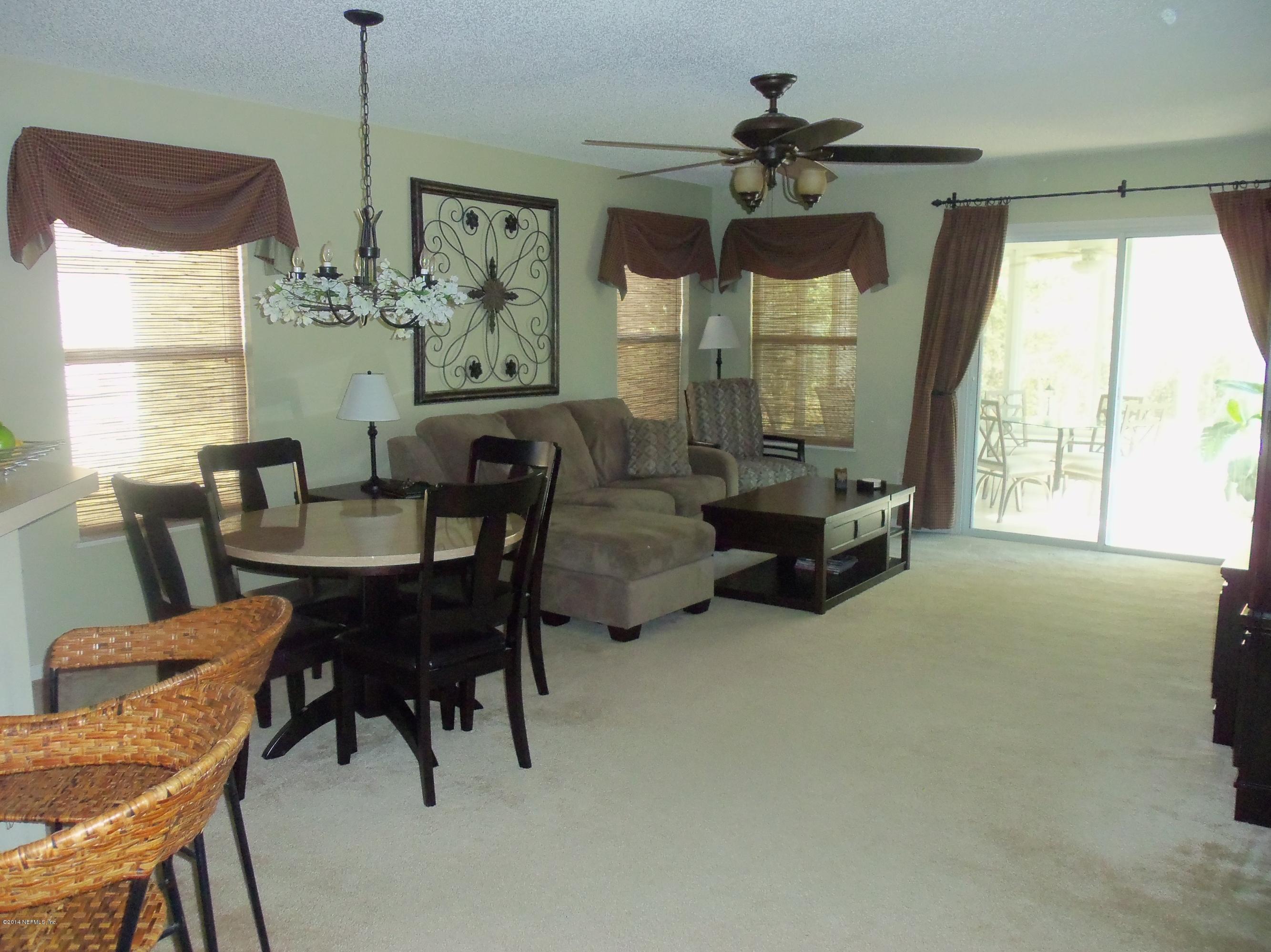 9732 Chirping Way Jacksonville, FL 32222 - Photo 7 of 27 a living room with furniture and a large window