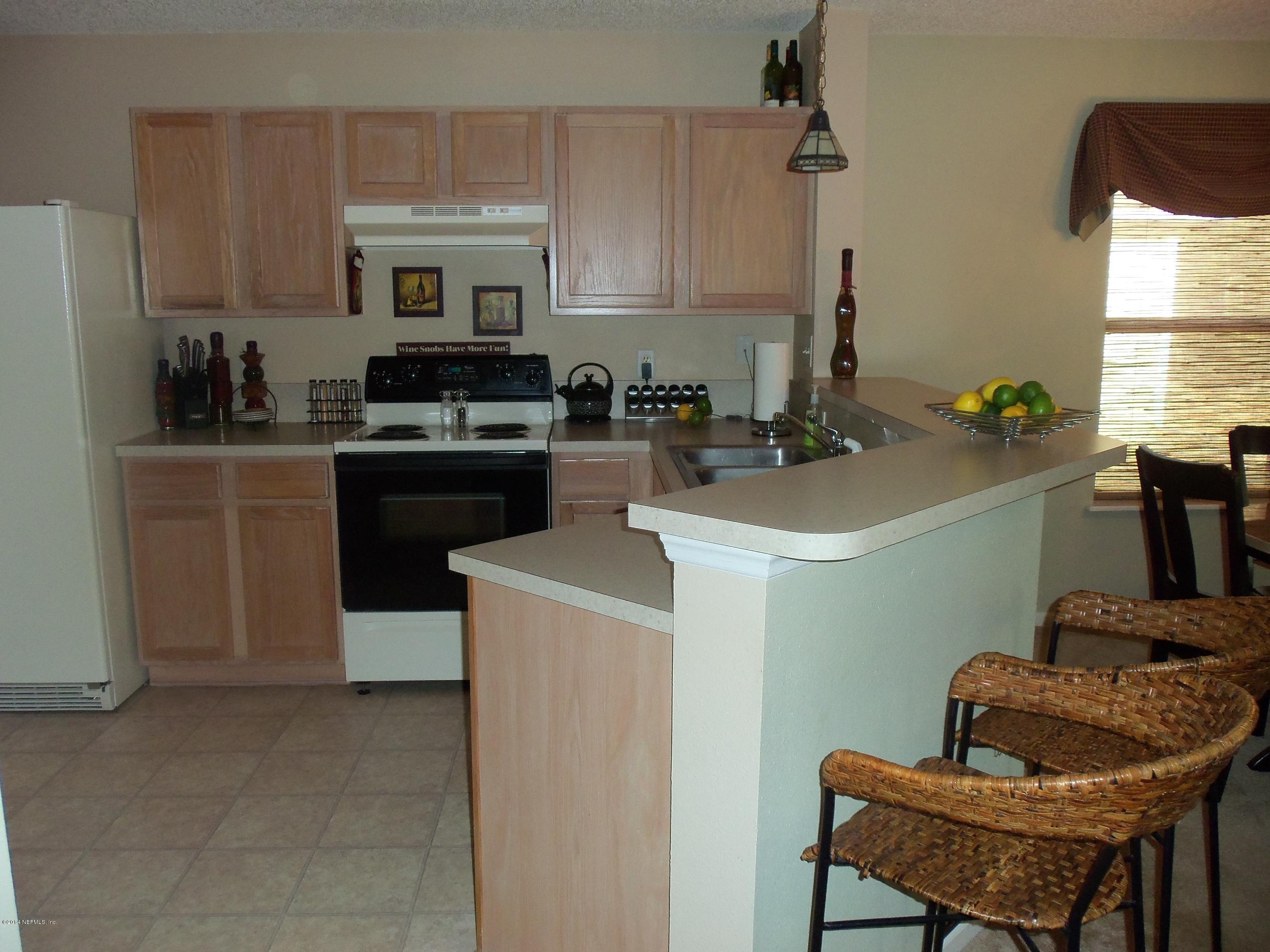 9732 Chirping Way Jacksonville, FL 32222 - Photo 8 of 27 a kitchen with a sink appliances and cabinets