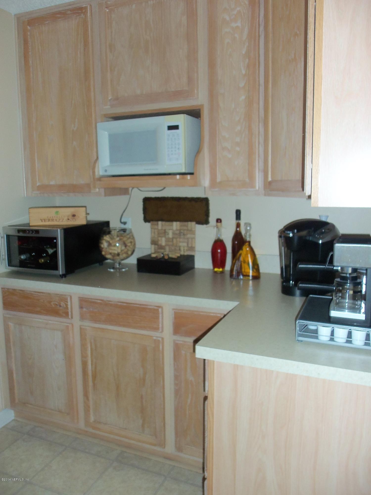 9732 Chirping Way Jacksonville, FL 32222 - Photo 9 of 27 a kitchen with a sink and a stove top oven