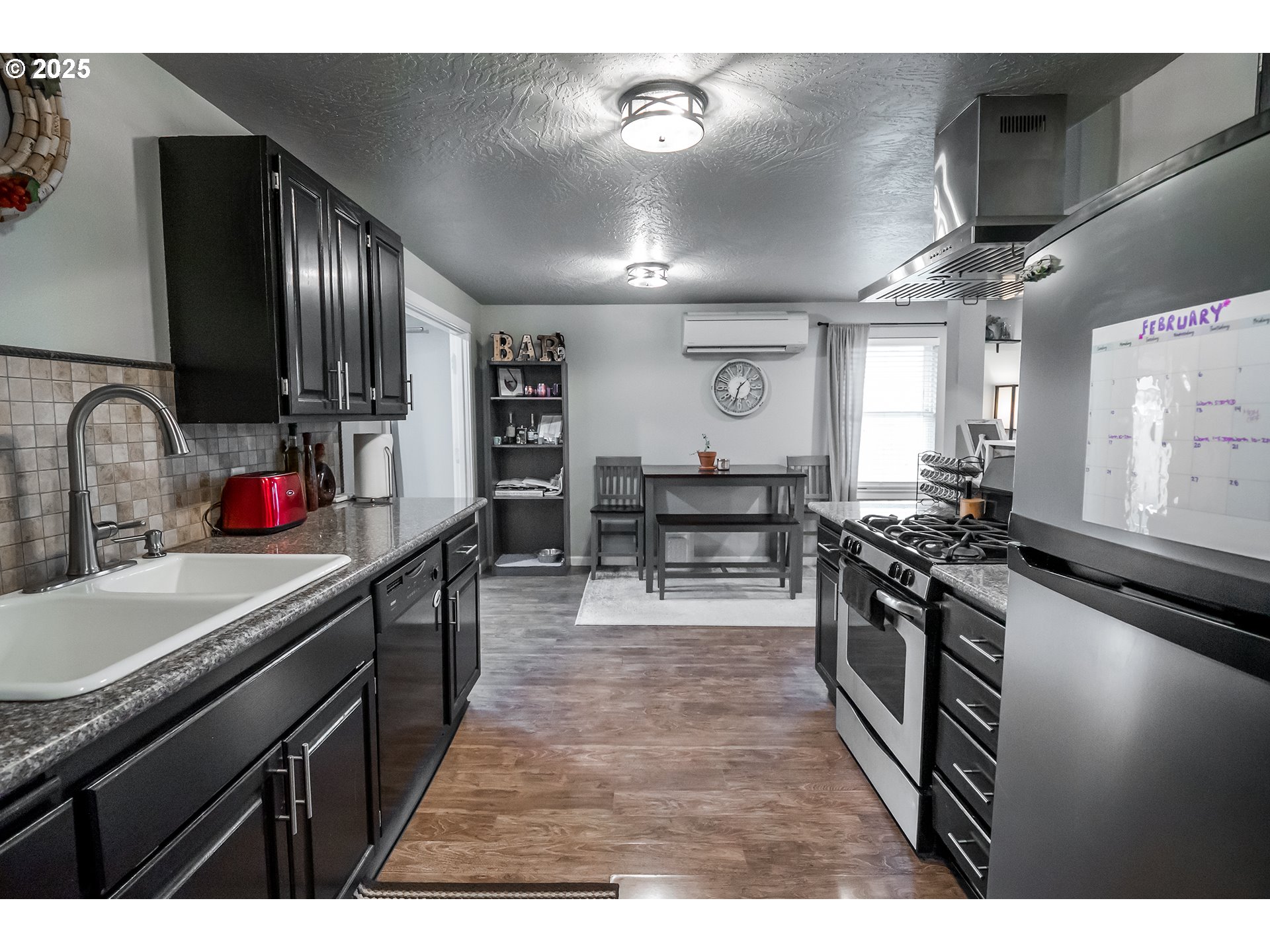 732 53rd Street Springfield, OR 97478 - Photo 11 of 27 a kitchen with kitchen island granite countertop lots of counter top space a sink and appliances