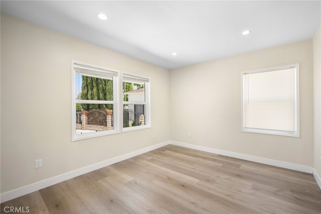 8435 Rincon Avenue Sun Valley, CA 91352 - Photo 10 of 61 an empty room with wooden floor and windows