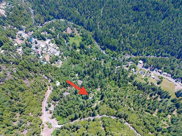 a view of a lush green hillside and a building