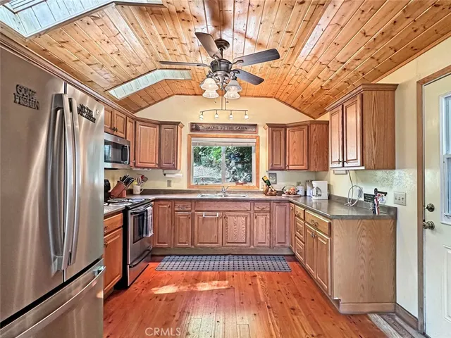 a view of a hallway with wooden floor and furniture