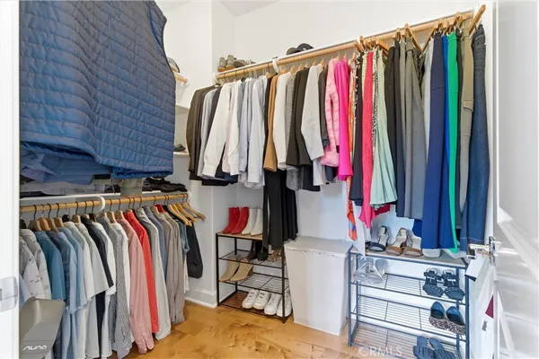 a view of walk in closet with clothes