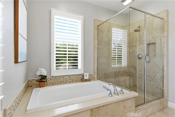 a white bath tub sitting next to a shower