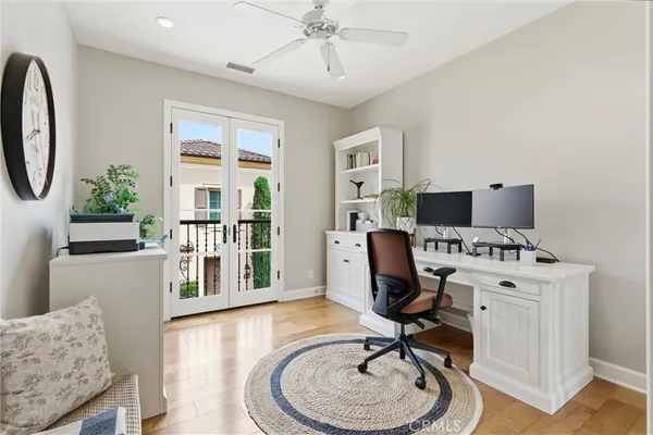 a view of a workspace with furniture and a window