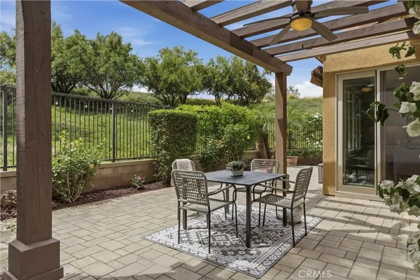 a view of a patio with a table and chairs