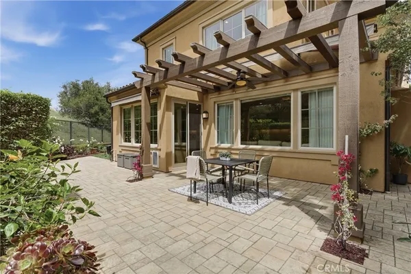a building outdoor space with patio furniture and potted plants