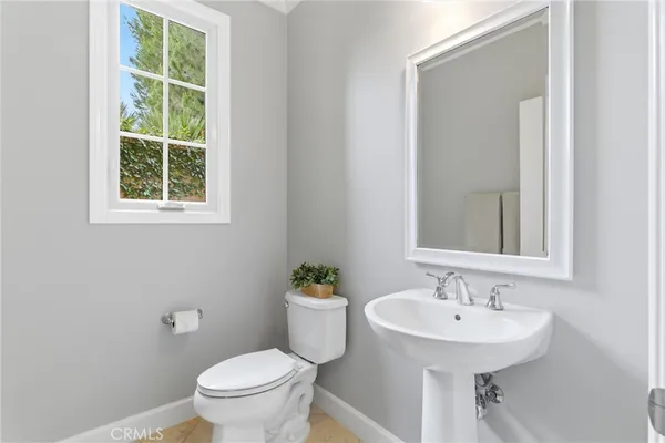 a bathroom with a sink toilet and a mirror