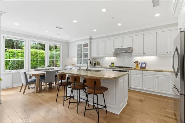 a kitchen with a table chairs sink and cabinets