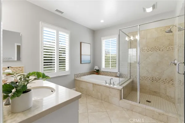 a bathroom with a tub shower and sink
