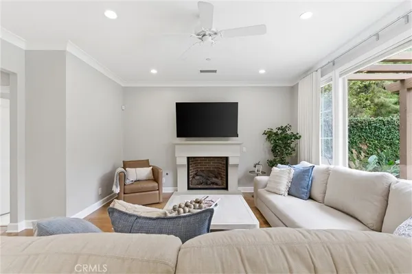 a living room with furniture a fireplace and a flat screen tv