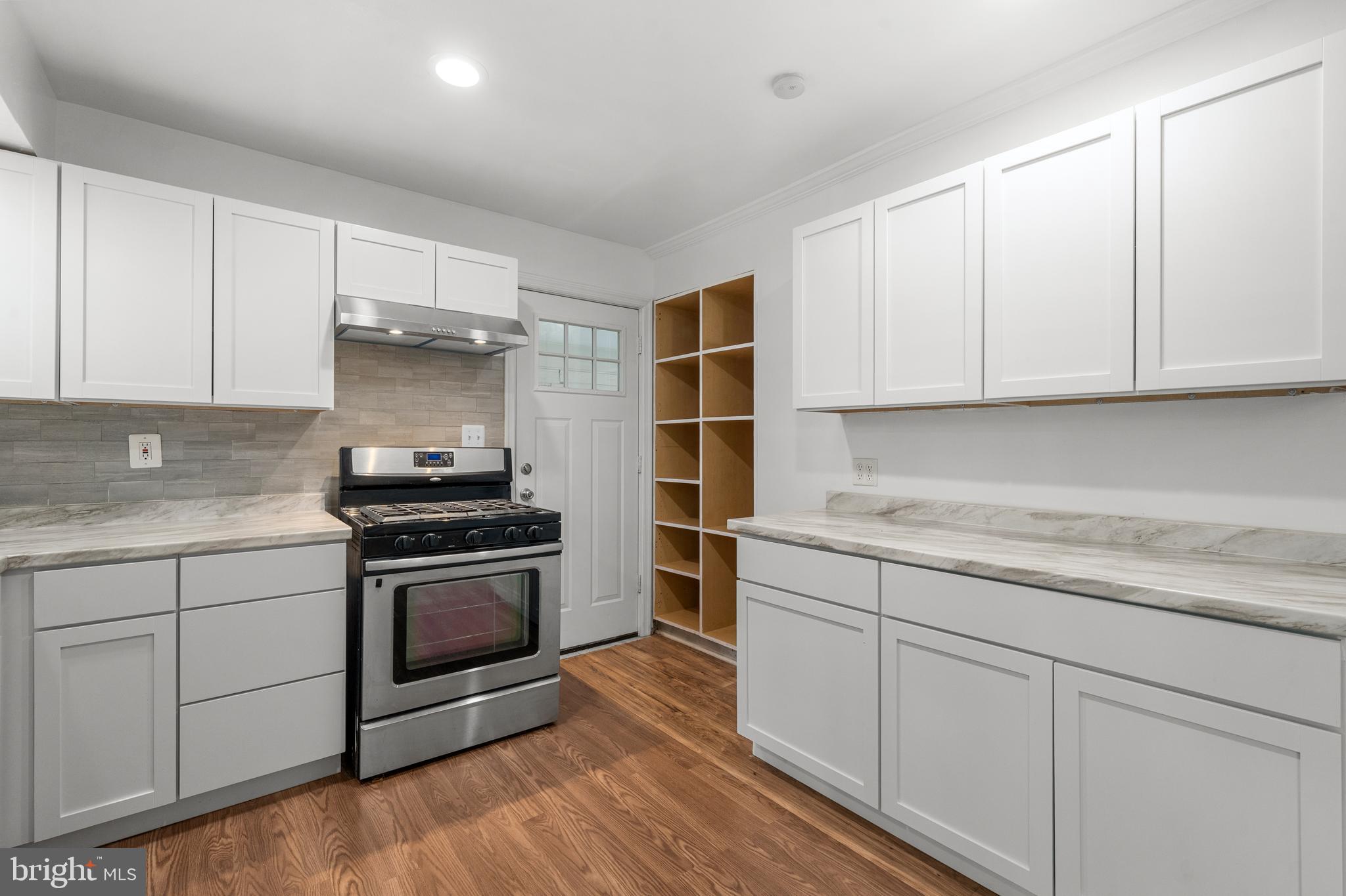 5505 Heming Avenue Springfield, VA 22151 - Photo 12 of 37 a kitchen with granite countertop white cabinets and stainless steel appliances