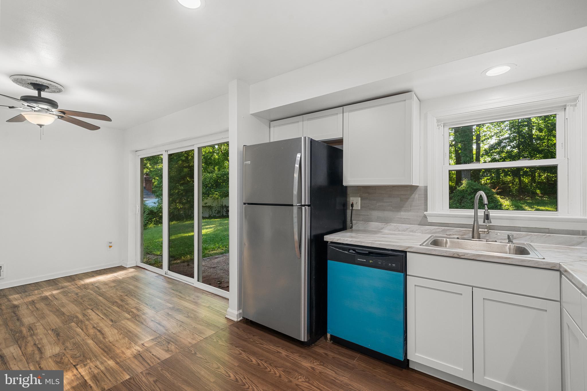 5505 Heming Avenue Springfield, VA 22151 - Photo 13 of 37 a kitchen with kitchen island a sink appliances and cabinets