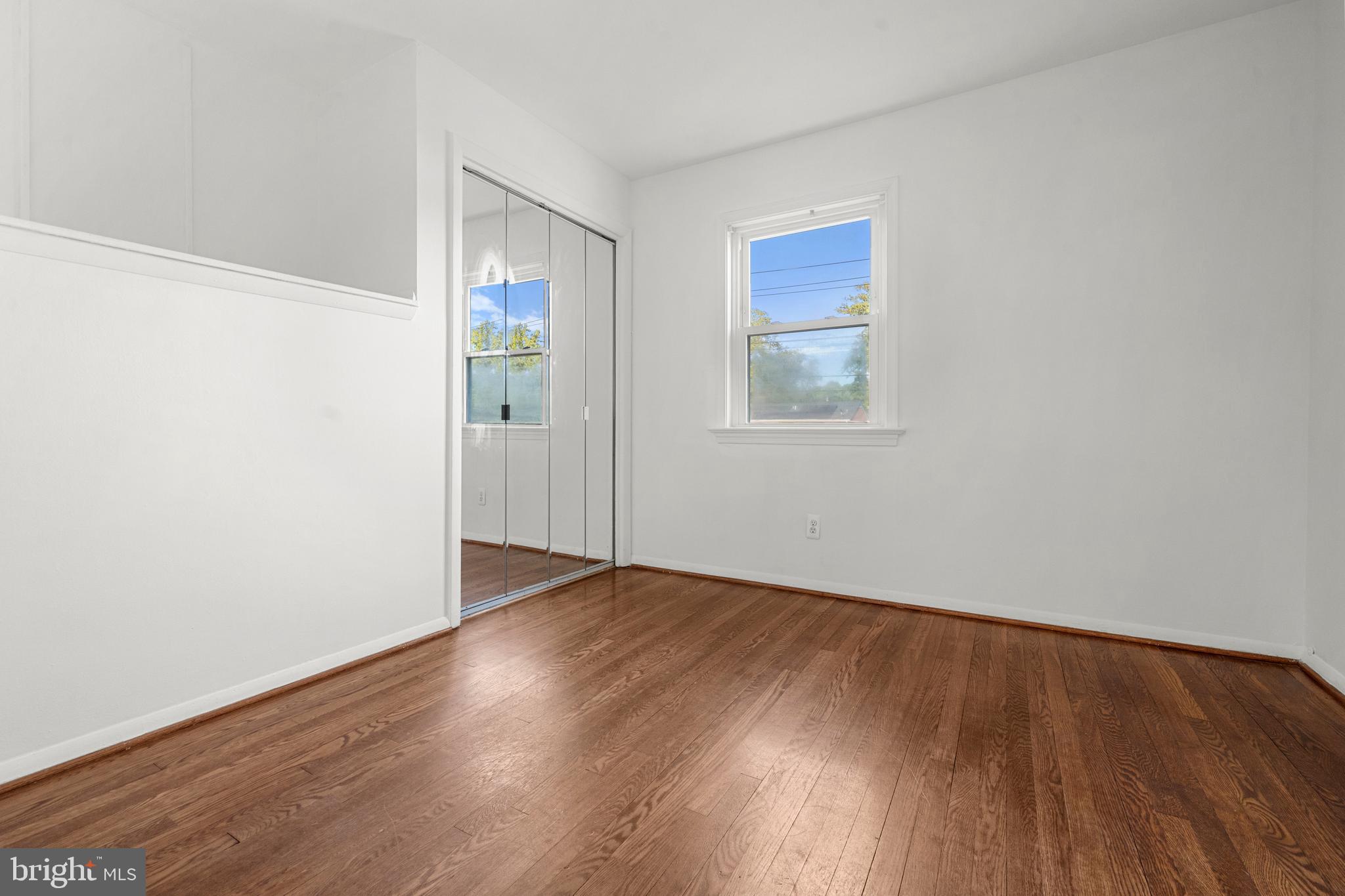 5505 Heming Avenue Springfield, VA 22151 - Photo 14 of 37 an empty room with wooden floor and windows