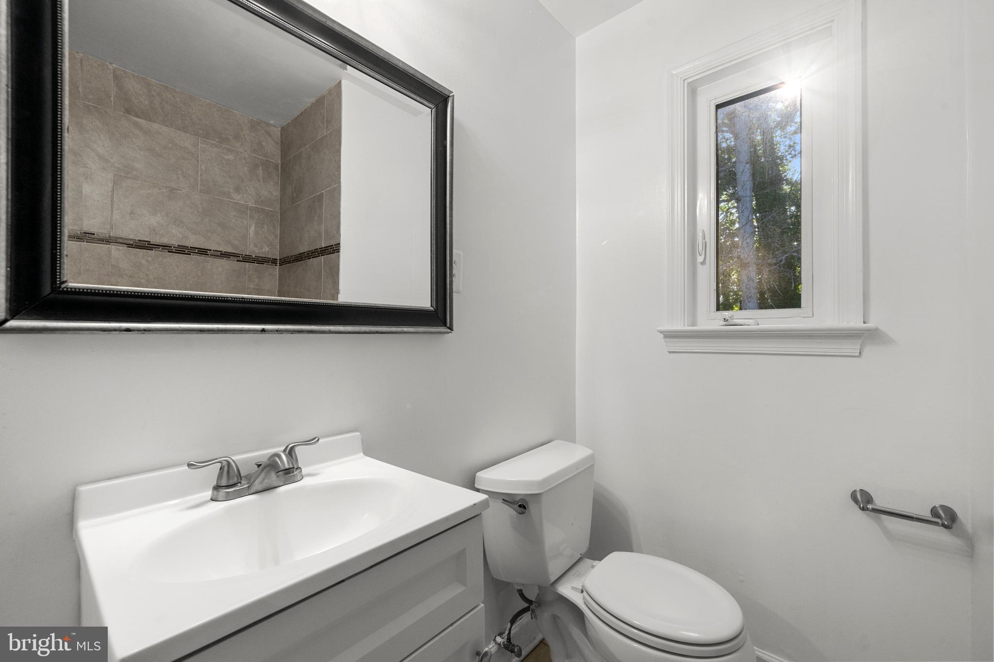 5505 Heming Avenue Springfield, VA 22151 - Photo 18 of 37 a bathroom with a toilet sink and mirror