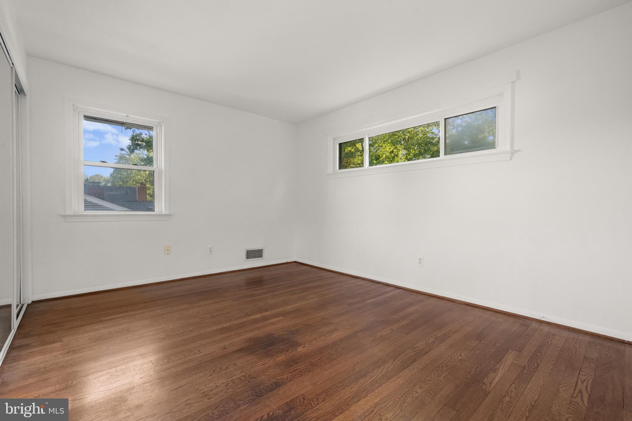5505 Heming Avenue Springfield, VA 22151 - Photo 21 of 37 a view of an empty room with wooden floor and a window