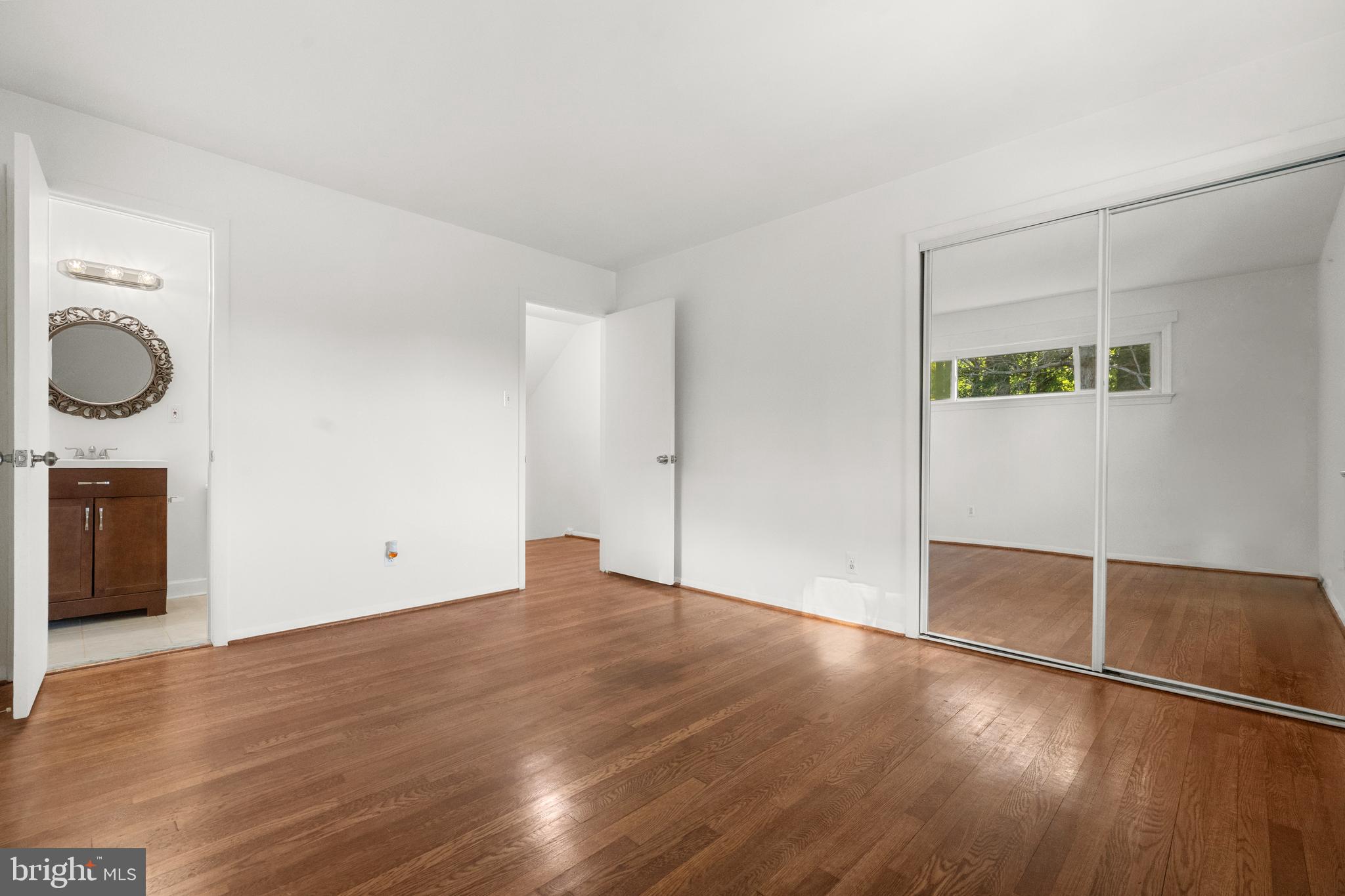 5505 Heming Avenue Springfield, VA 22151 - Photo 22 of 37 a view of an empty room with wooden floor and a window