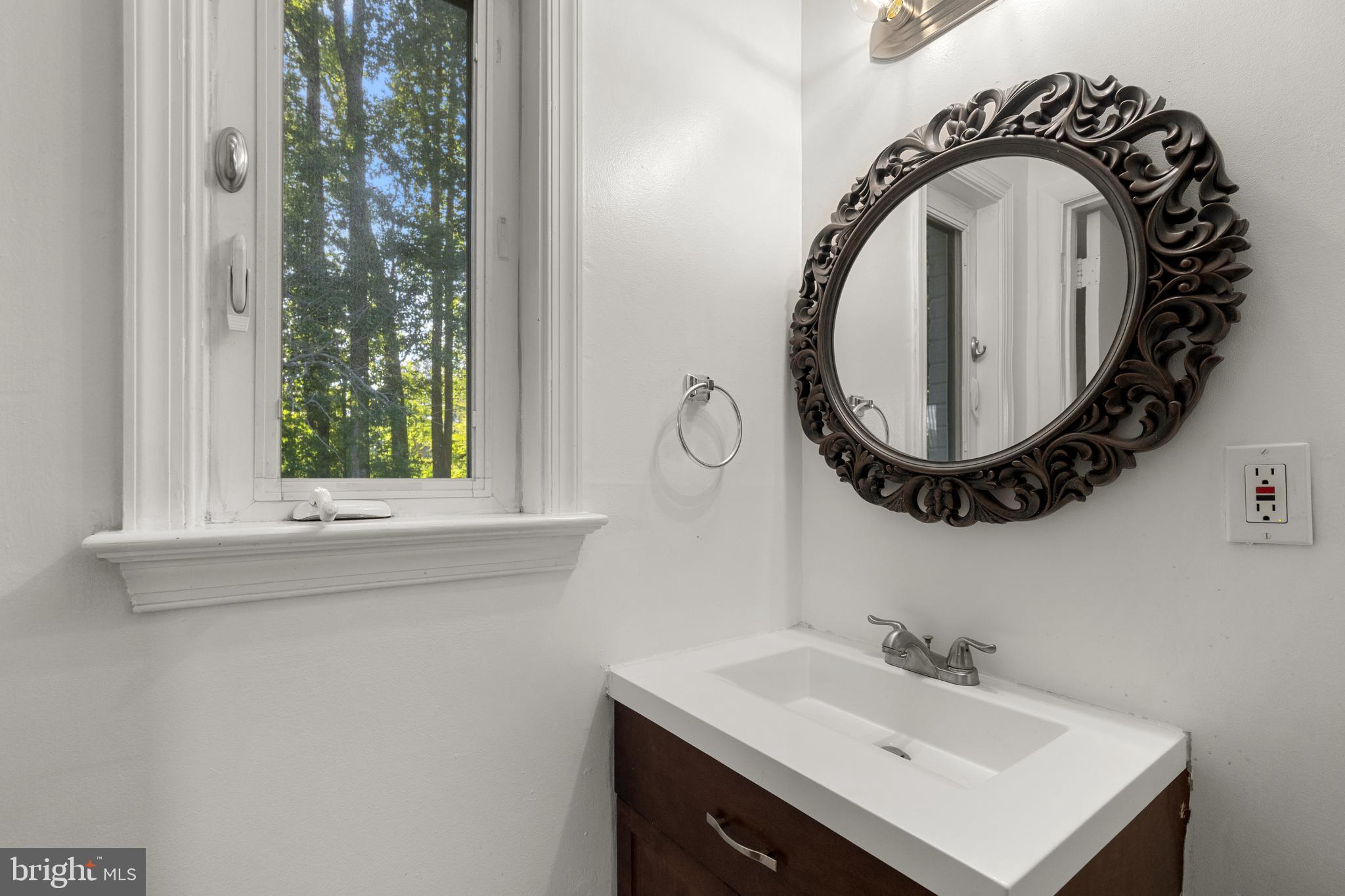 5505 Heming Avenue Springfield, VA 22151 - Photo 23 of 37 a bathroom with a sink and a mirror